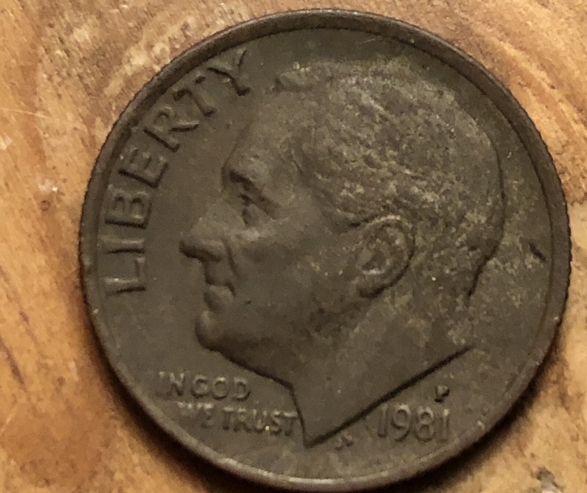 1981 Roosevelt dime struck on a wrong planchet error — incorrect color and size compared to a normal dime