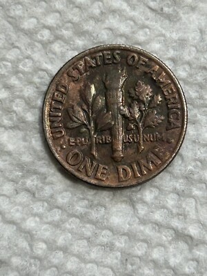 1981 Roosevelt dime missing clad layer error showing reddish copper core on one side versus normal silvery clad finish