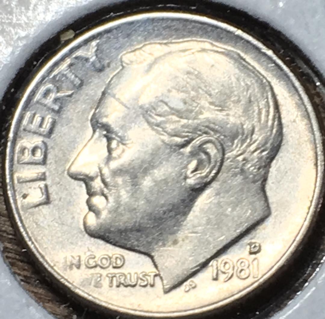 1981-D Roosevelt dime repunched mint mark error under 10x magnification showing doubled D shadow alongside primary mint mark
